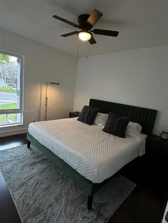 a bedroom with bed and window