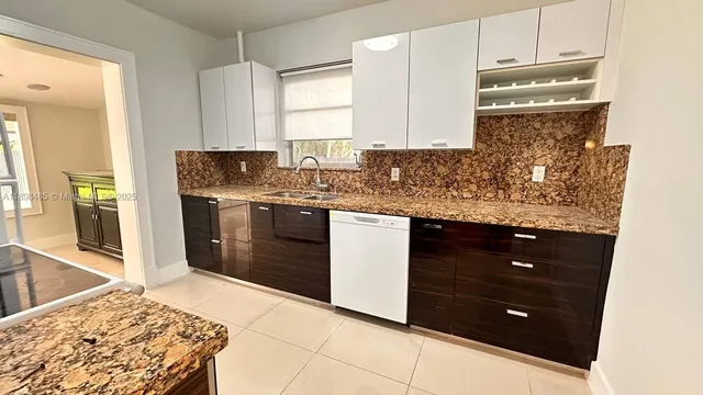 a kitchen with stainless steel appliances granite countertop a stove and a sink