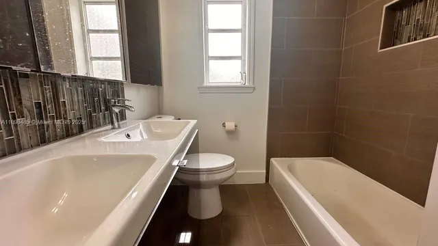 a bathroom with a sink a toilet and tub