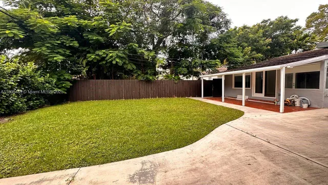 a view of swimming pool with lawn chairs and plants