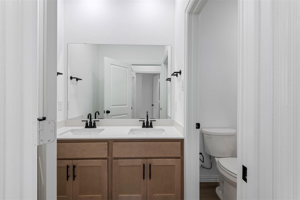 2011 Redtail Drive Melissa, TX 75454 - Photo 14 of 27 a bathroom with a sink toilet and vanity