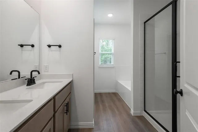a bathroom with a sink a mirror and a shower