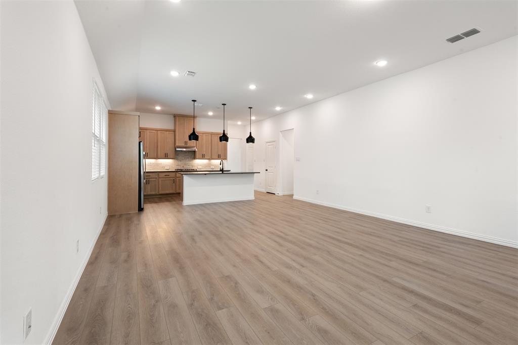 2011 Redtail Drive Melissa, TX 75454 - Photo 4 of 27 a view of a kitchen with kitchen island a sink wooden floor and counter top space