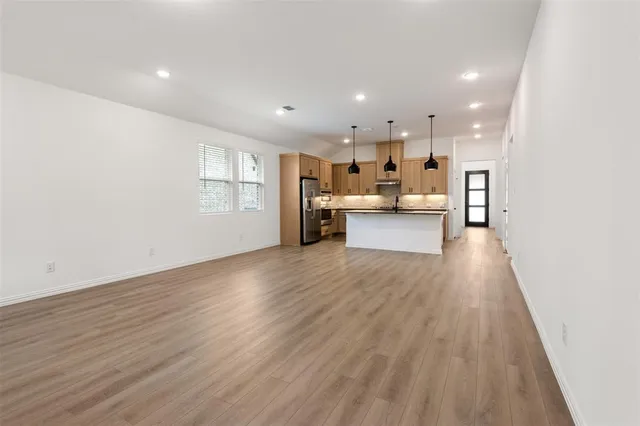 a view of kitchen dining table chairs cabinets and wooden floor