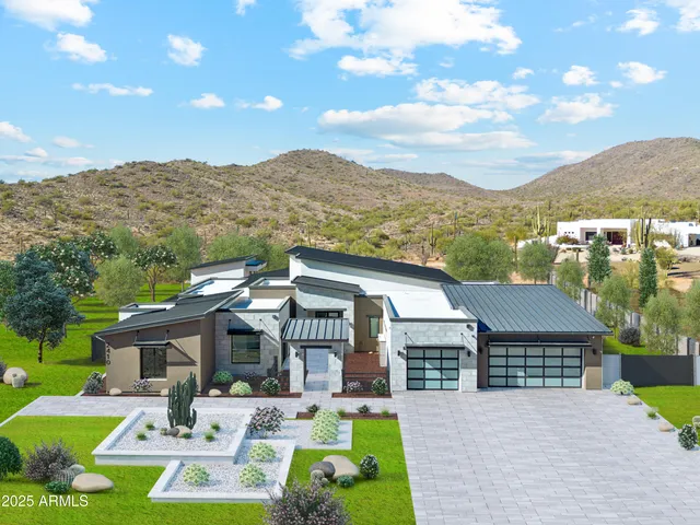 a front view of house with yard outdoor seating and mountain view in back