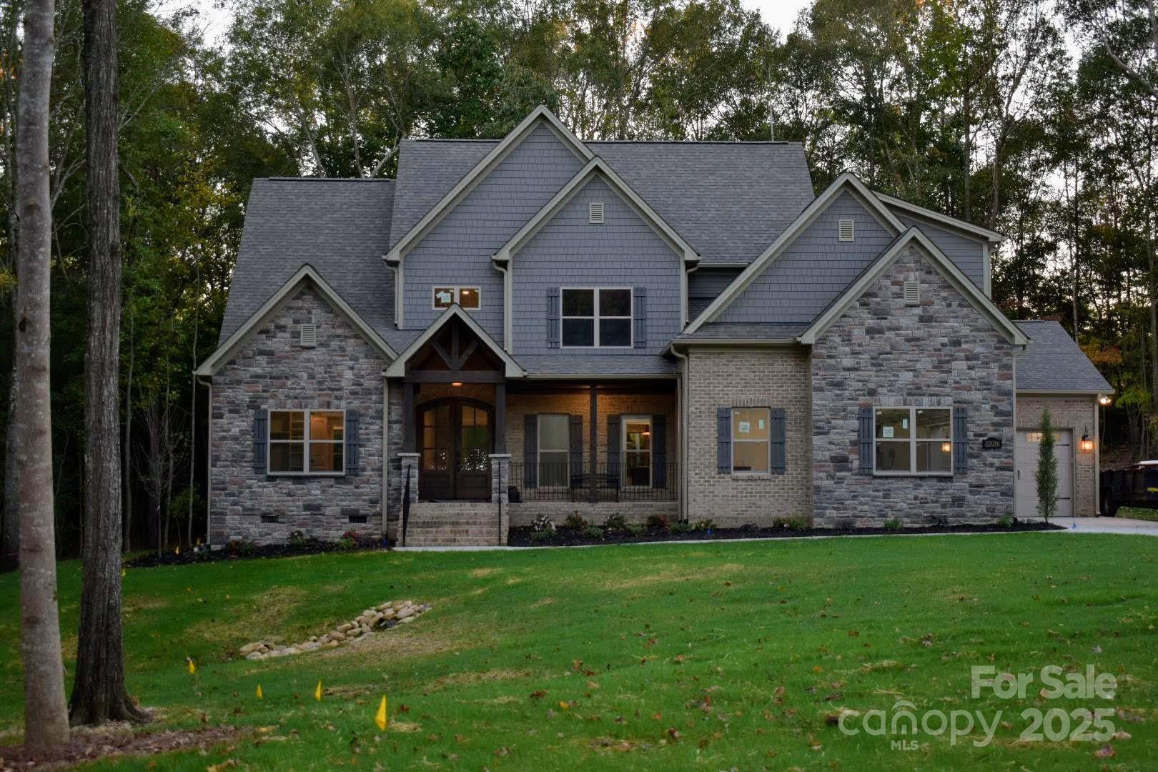6507 Rehobeth Road, Unit 4 Waxhaw, NC 28173 - Photo 2 of 10 a front view of a house with a garden