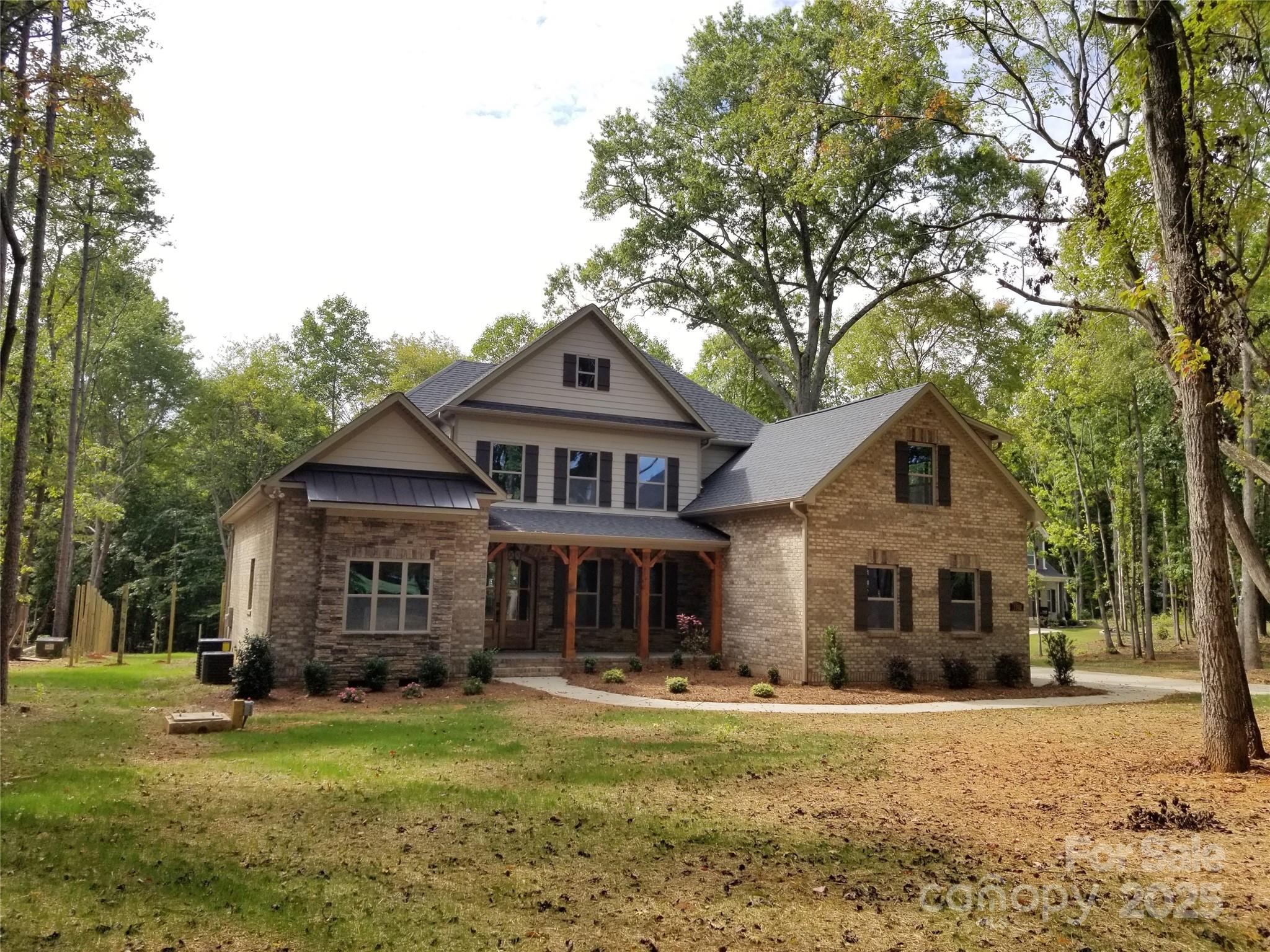 6507 Rehobeth Road, Unit 4 Waxhaw, NC 28173 - Photo 4 of 10 a front view of a house with a garden