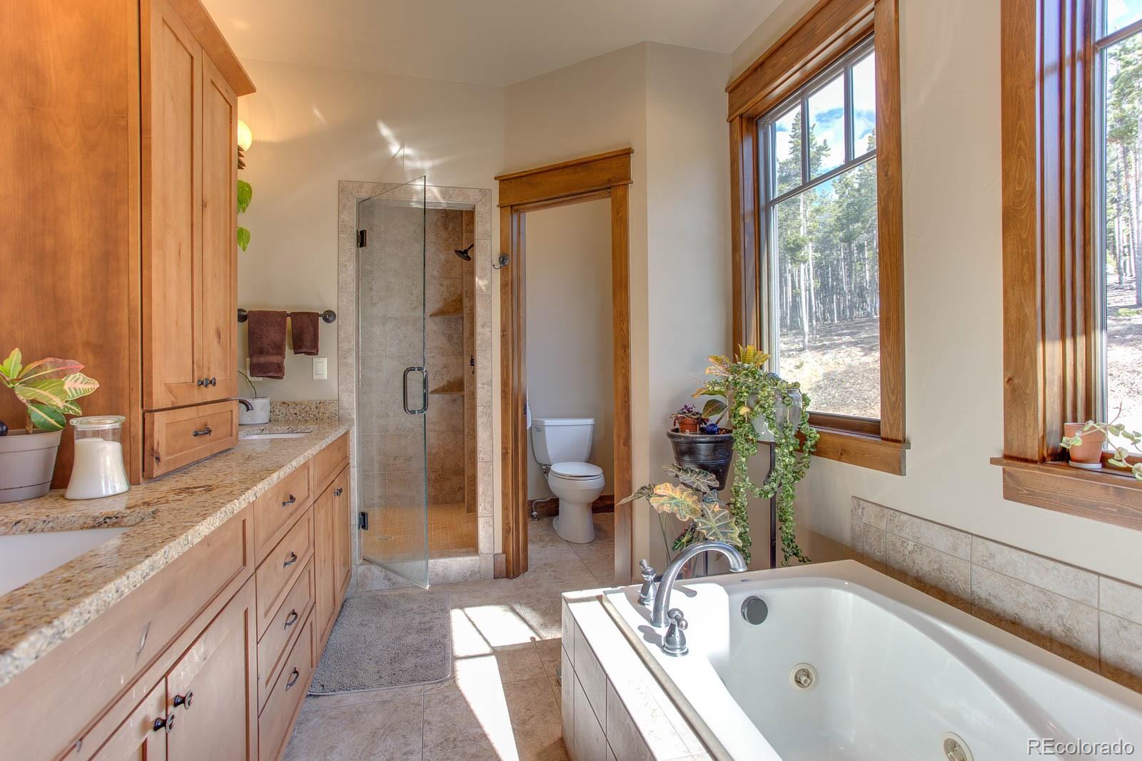 398 Crescent Lake Road Golden, CO 80403 - Photo 17 of 25 a spacious bathroom with a tub sink and mirror
