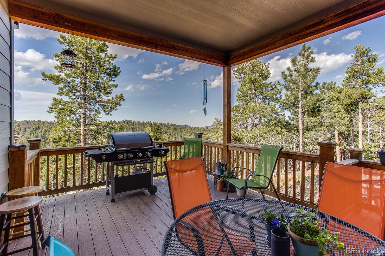 398 Crescent Lake Road Golden, CO 80403 - Photo 9 of 25 a balcony with wooden floor table and chairs