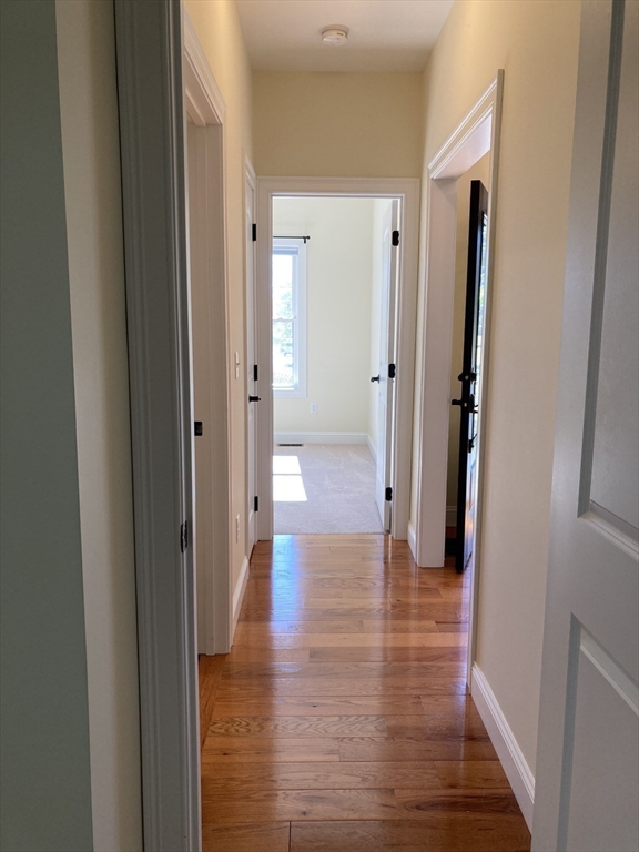 28 Spring Street Petersham, MA 01366 - Photo 17 of 31 a view of a hallway with wooden floor and a bathroom