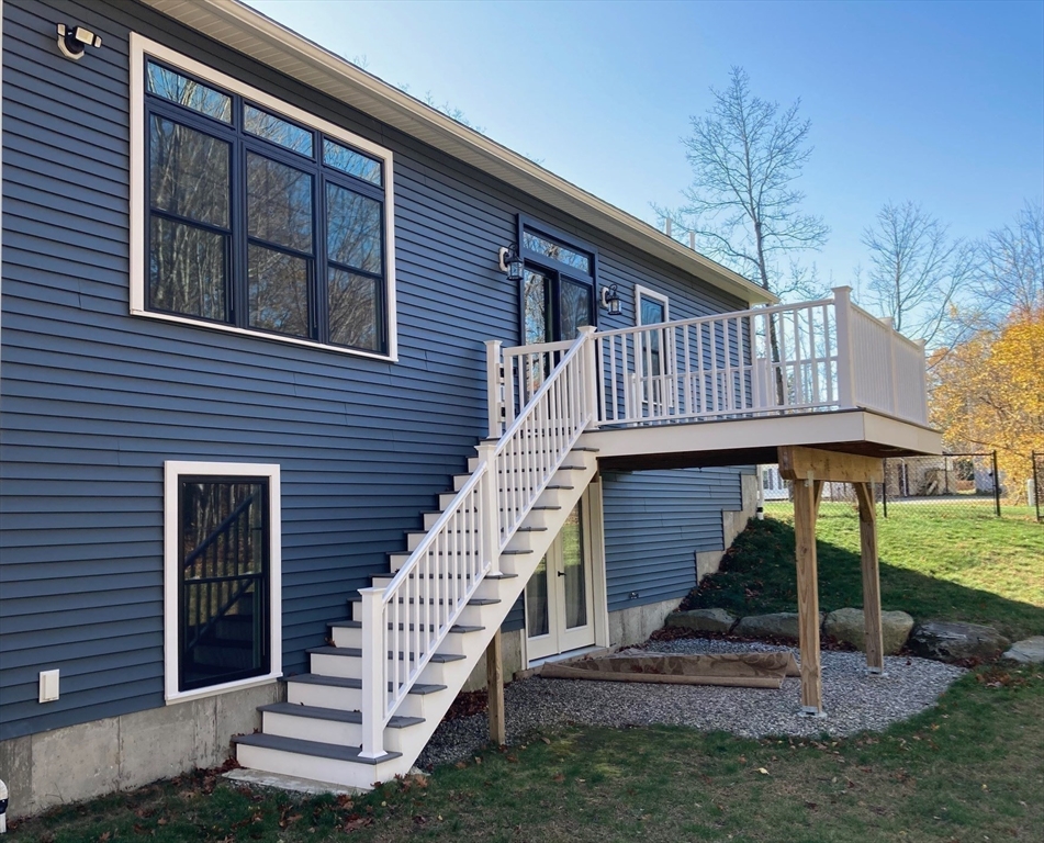 28 Spring Street Petersham, MA 01366 - Photo 20 of 31 a view of a house with a yard deck and a large tree