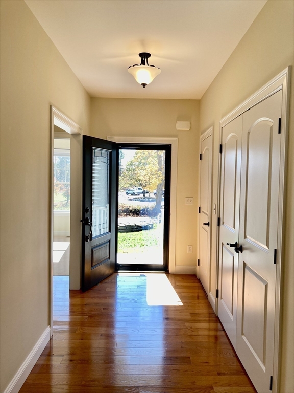 28 Spring Street Petersham, MA 01366 - Photo 6 of 31 a view of a hallway with wooden floor and a cabinet