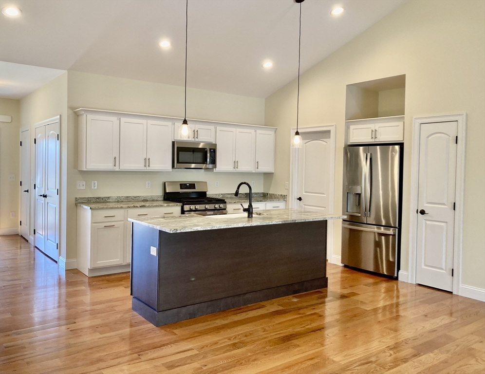 28 Spring Street Petersham, MA 01366 - Photo 9 of 31 a kitchen with stainless steel appliances granite countertop a refrigerator stove a sink and a microwave
