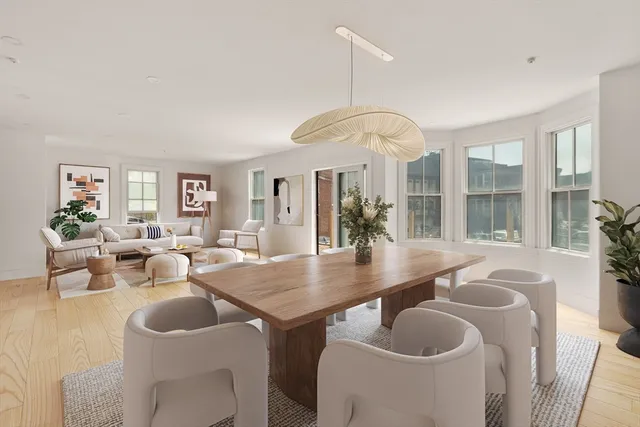 a dining room with furniture a chandelier and window