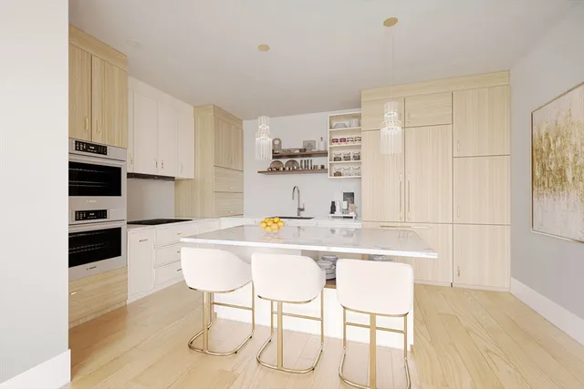 a kitchen with stainless steel appliances kitchen island granite countertop a sink and cabinets