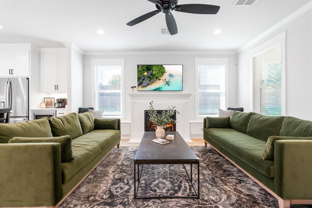 a living room with furniture a fireplace and a window