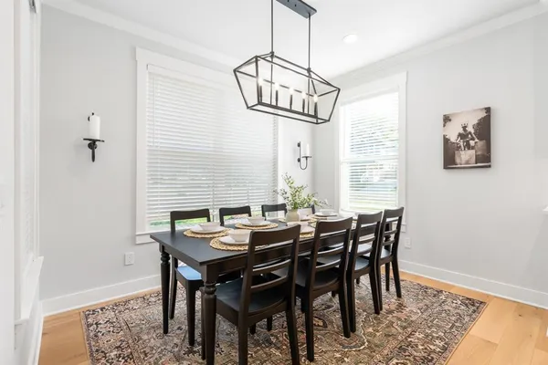a view of a dining room with furniture window and wooden floor