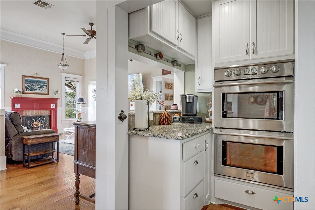 13471 Cedar Valley Road Salado, TX 76571 - Photo 12 of 39 a kitchen with stainless steel appliances granite countertop a stove and a refrigerator