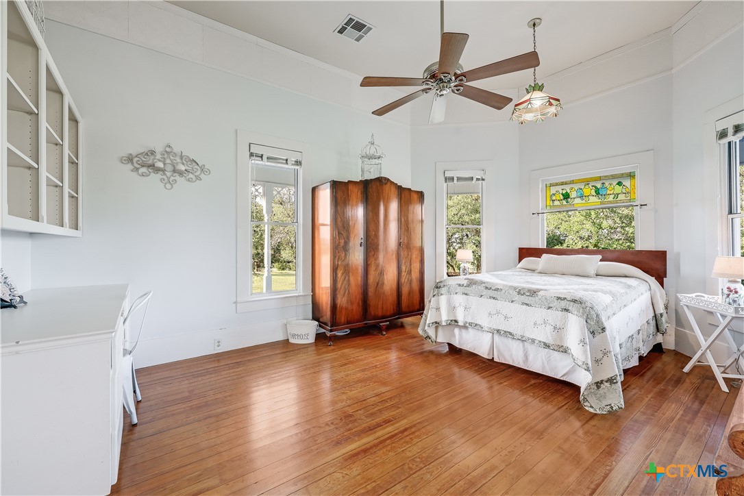 13471 Cedar Valley Road Salado, TX 76571 - Photo 17 of 39 a bedroom with a bed and a chandelier