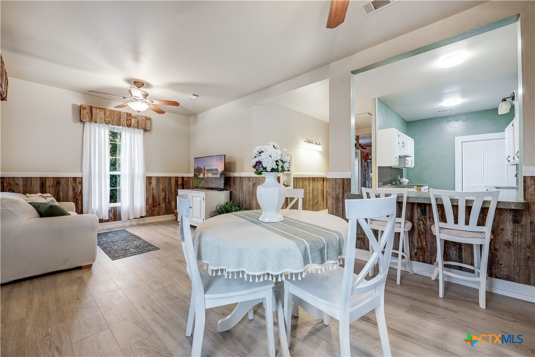 13471 Cedar Valley Road Salado, TX 76571 - Photo 28 of 39 a view of a dining room with furniture and wooden floor