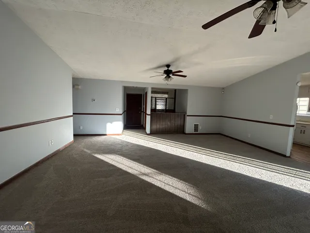 a view of empty room with a fireplace