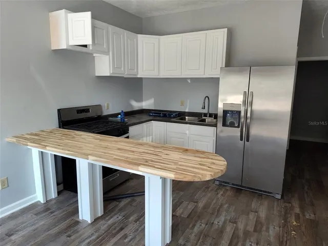 a kitchen with cabinets and stainless steel appliances