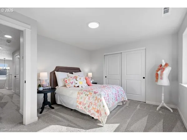 a bedroom with a bed and a lamp