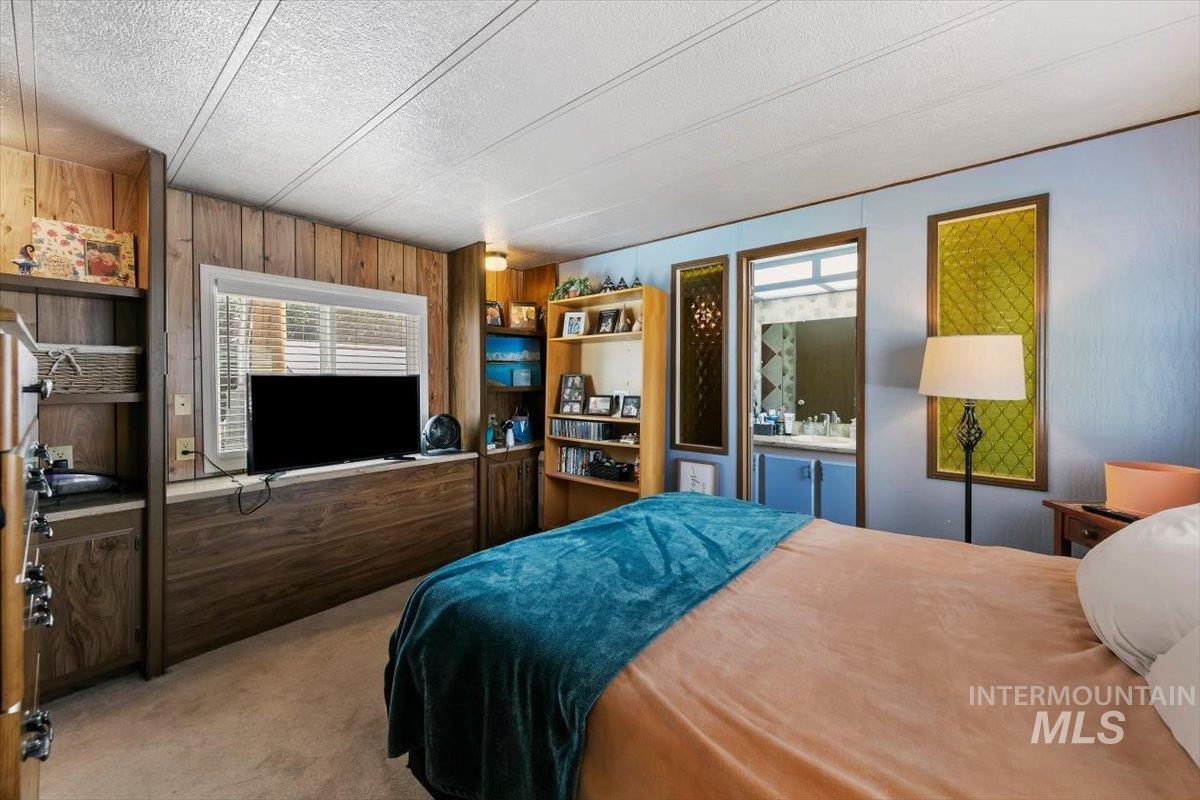 915 South Curtis Road, Unit 68 Boise City, ID 83705 - Photo 8 of 20 Built-in shelving, wood-finish paneling, and a private vanity area