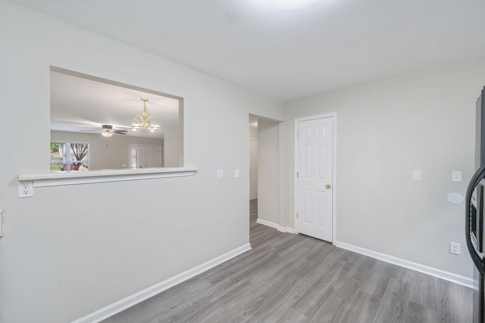 242 Wainwright Drive Crestview, FL 32539 - Photo 14 of 43 a view of an empty room with wooden floor and a window