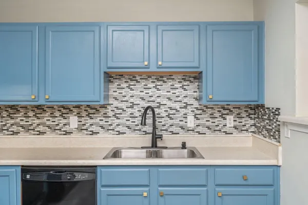 a kitchen with a sink and cabinets