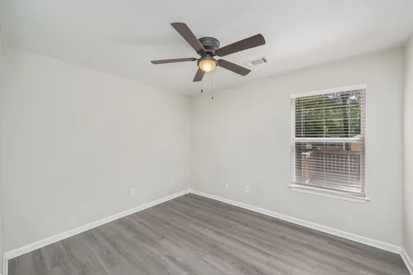 a view of a livingroom with a ceiling fan and wooden floor