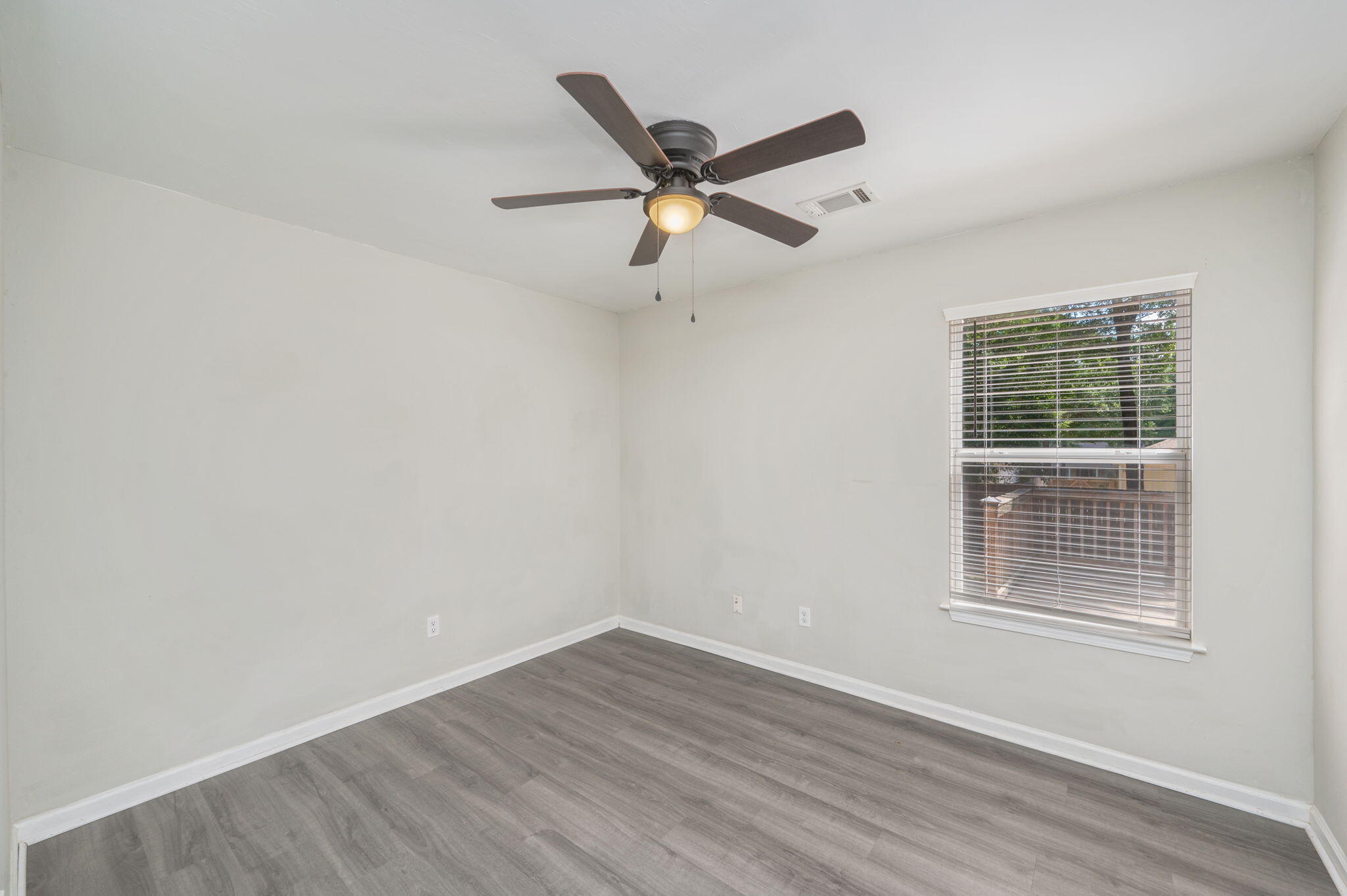 242 Wainwright Drive Crestview, FL 32539 - Photo 16 of 43 a view of a livingroom with a ceiling fan and wooden floor