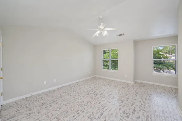 wooden floor in an empty room with a window