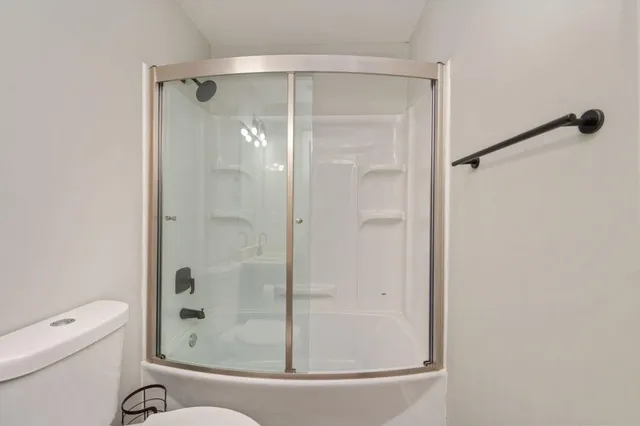 a bathroom with a shower and a toilet