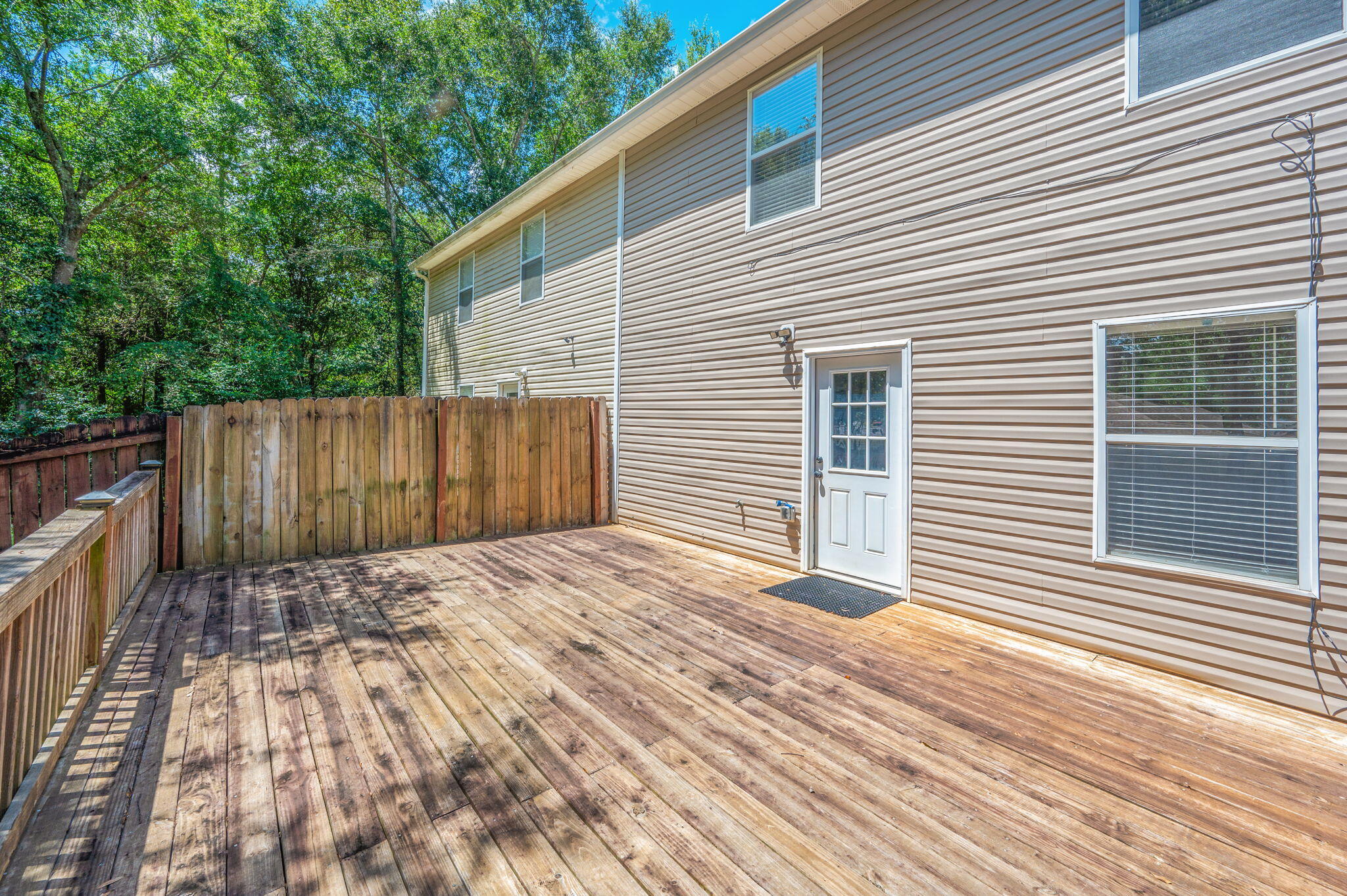 242 Wainwright Drive Crestview, FL 32539 - Photo 40 of 43 a view of backyard with wooden fence and large trees