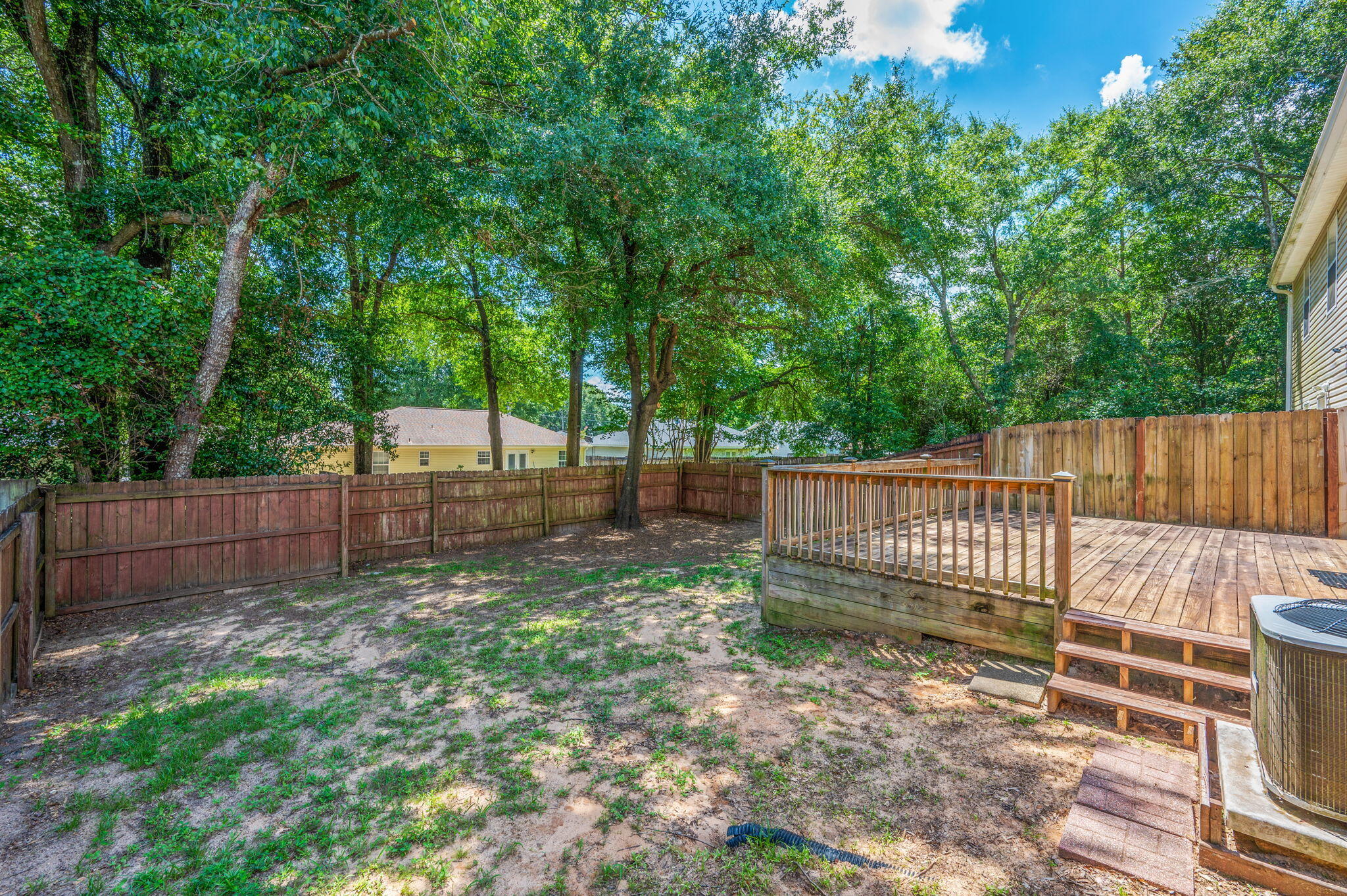 242 Wainwright Drive Crestview, FL 32539 - Photo 43 of 43 a view of a backyard with large trees and wooden fence