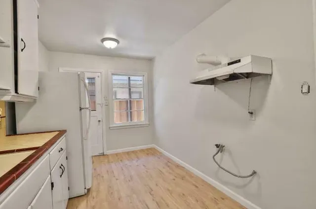a kitchen with stainless steel appliances a refrigerator and cabinets