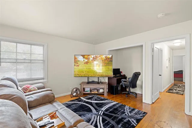 a view of a livingroom with furniture and a flat screen tv