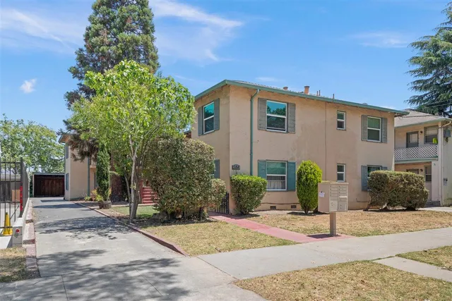 a view of a house with a yard and plants