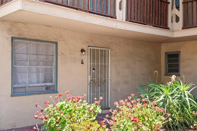 a front view of house along with deck and outdoor seating