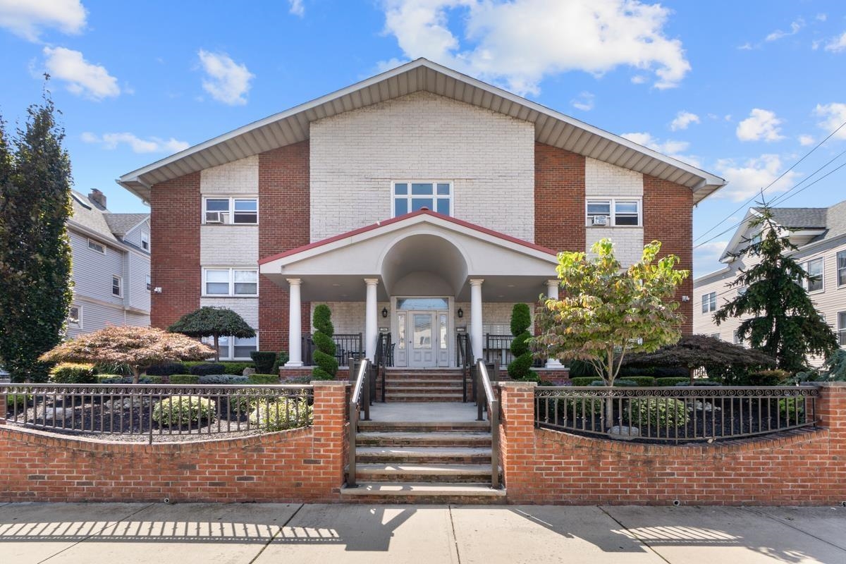 a front view of a house with plants