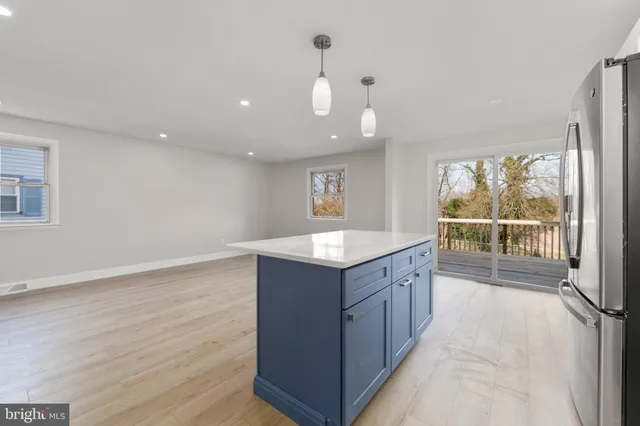 a view of kitchen with granite countertop cabinets and wooden floor