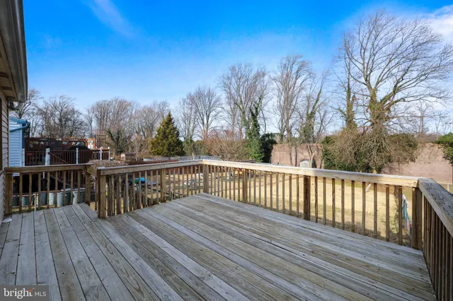a view of deck with wooden floor and trees