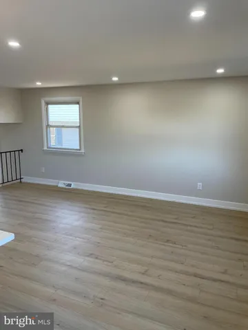 a view of a room with wooden floor and cabinet