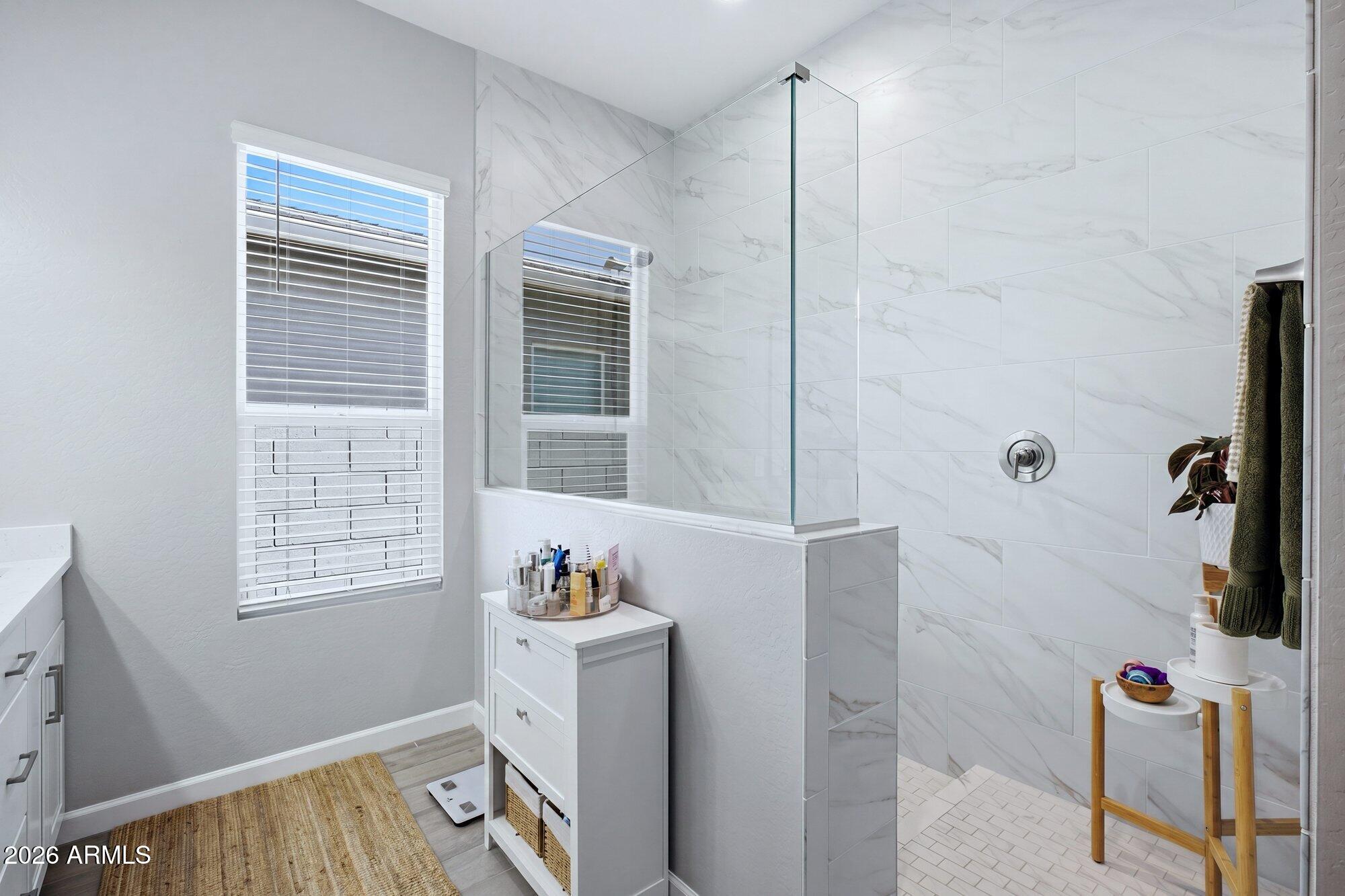 5963 East Lone Cactus Road Phoenix, AZ 85054 - Photo 12 of 22 a bathroom with a window and a shower