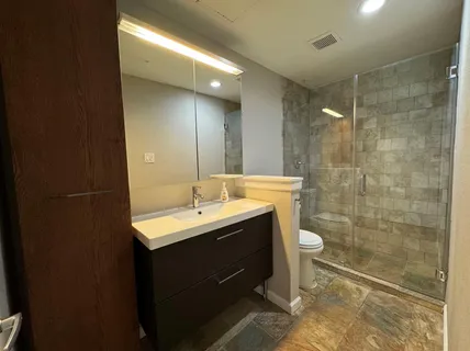 a bathroom with a double vanity sink toilet and a mirror