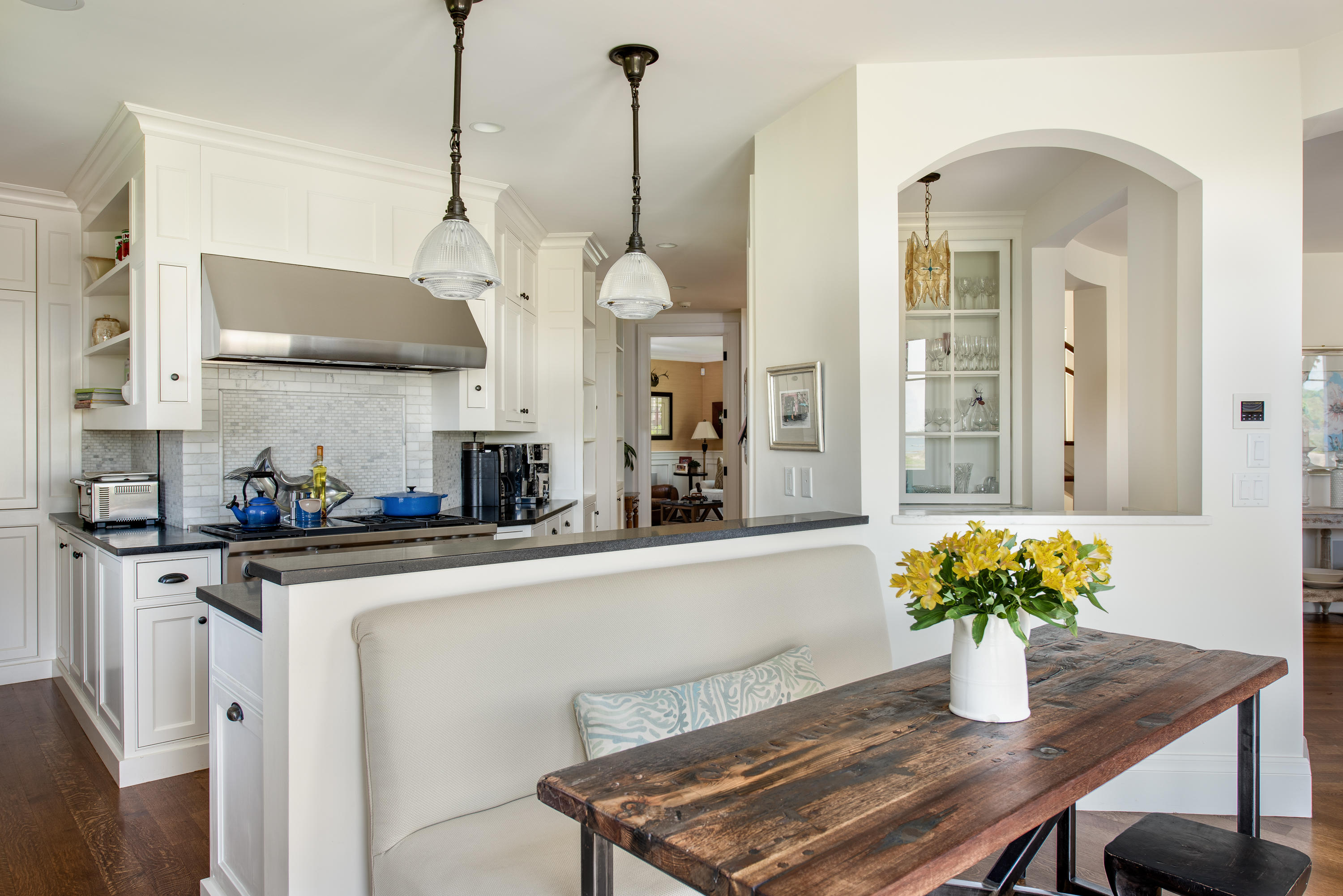 85 Salten Point Road Barnstable, MA 02630 - Photo 15 of 34 a kitchen with stainless steel appliances granite countertop a dining table chairs and white cabinets