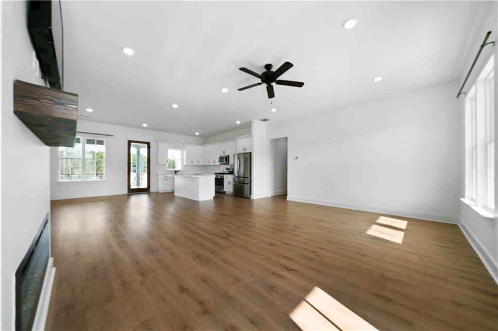 19 Trotters Lane Rome, GA 30165 - Photo 15 of 44 a view of empty room with wooden floor and windows