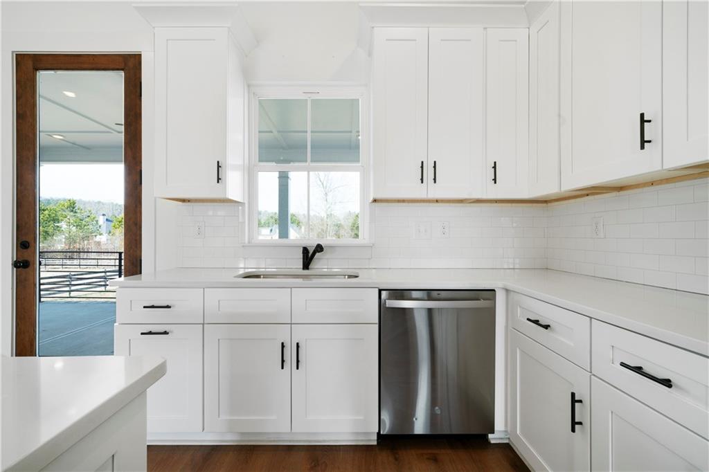 19 Trotters Lane Rome, GA 30165 - Photo 24 of 44 a kitchen with granite countertop white cabinets and white appliances