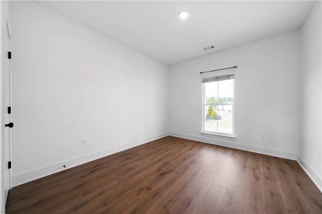 19 Trotters Lane Rome, GA 30165 - Photo 26 of 44 an empty room with wooden floor and windows